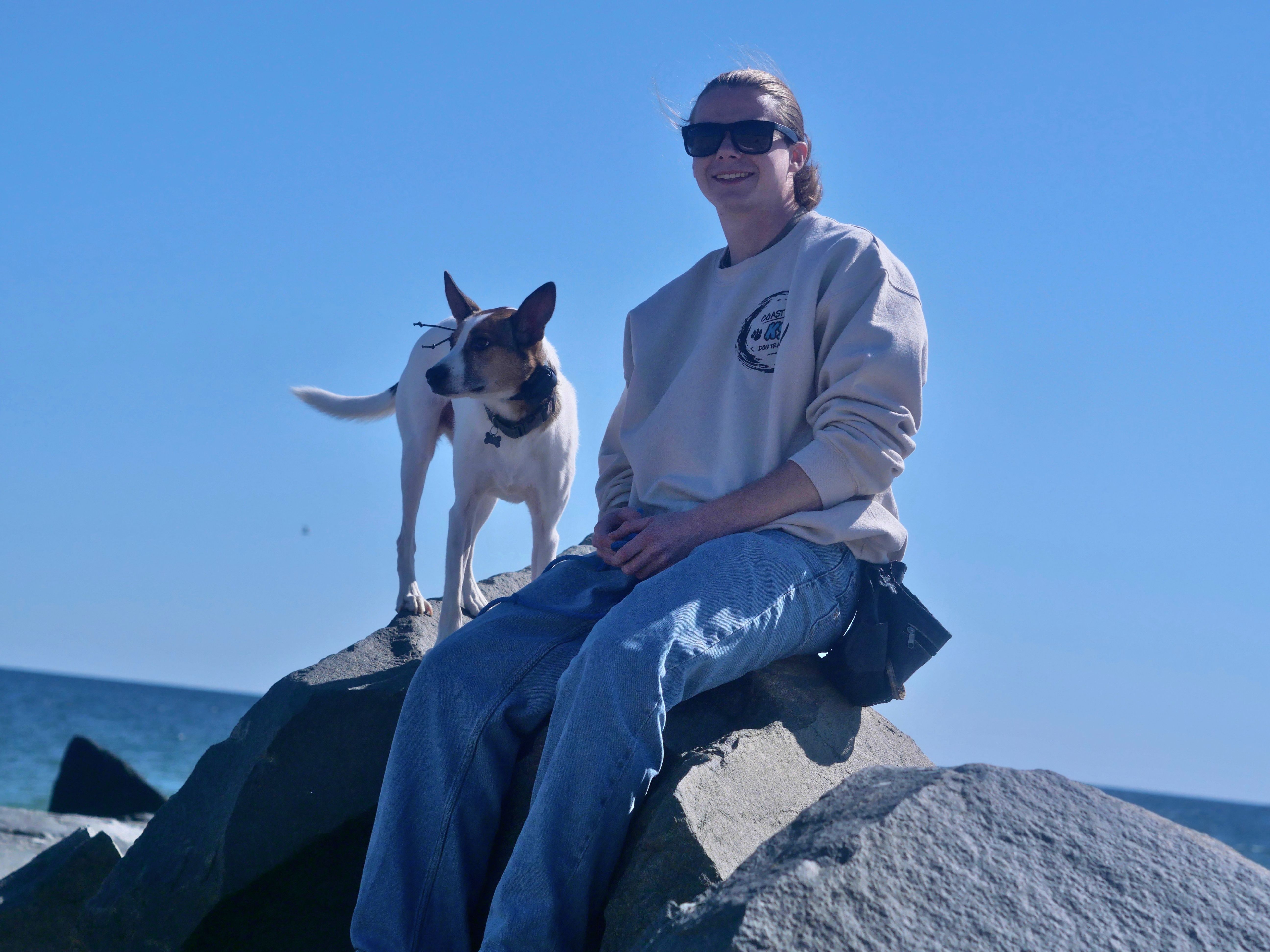 Dylan with his dog by the ocean